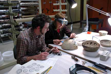 Conservators surveying MIAC collection.