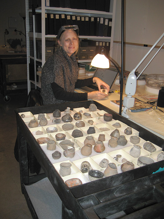 Conservation graduate student intern, Crista Pack, surveys minature pots.
